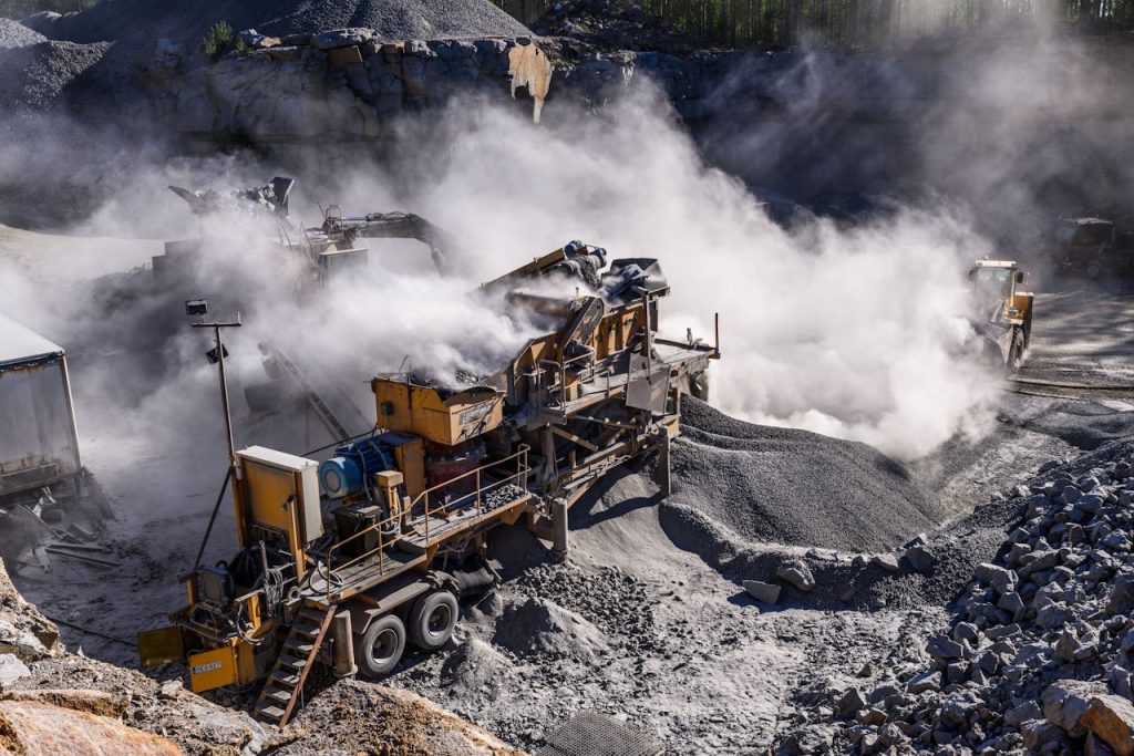 heavy-machinery-on-a-construction-site-4946889 A dynamic industrial quarry scene in Honkajoki, Finland, showcasing heavy machinery and dust clouds.